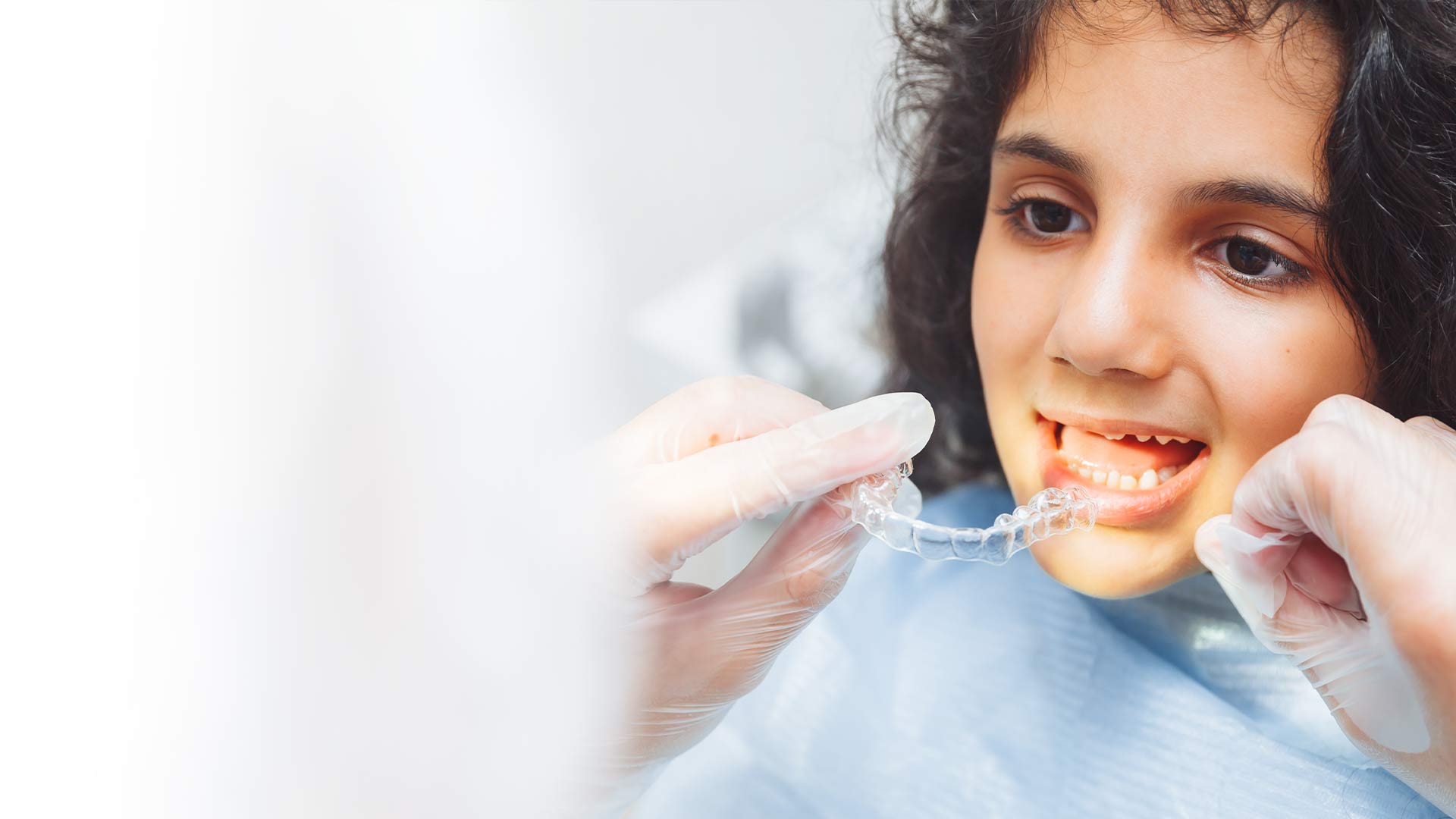 teenager being given teeth aligners