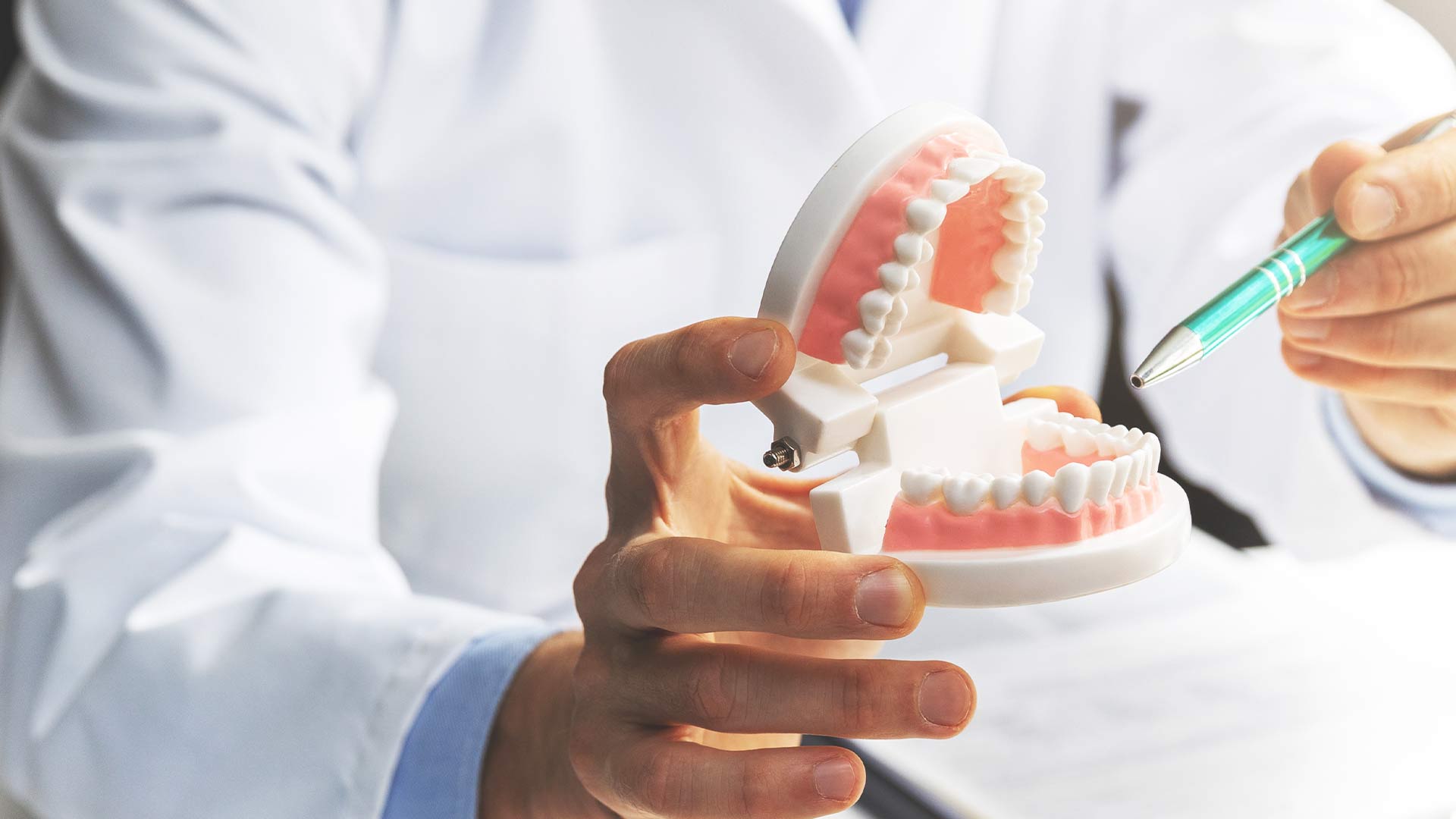 dentist demonstrating dental implants