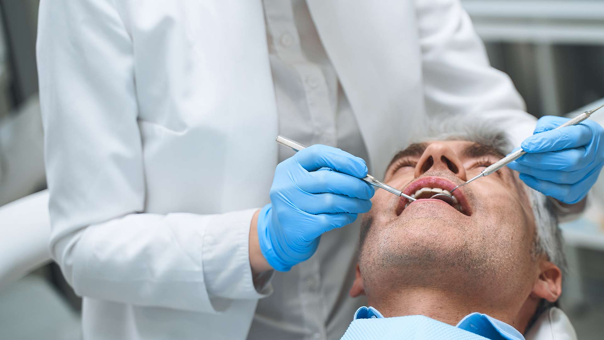 dentist performing veneers service to patient