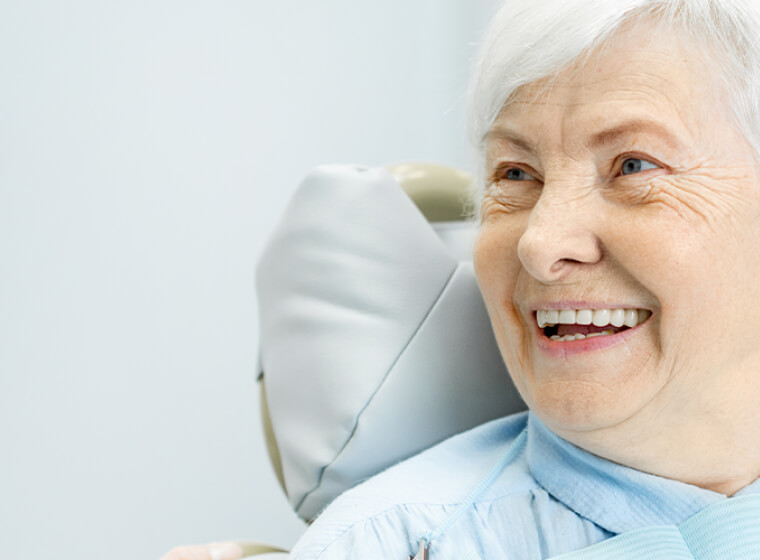Patient smiling to reveal their dentures