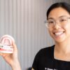 Dr. Serene Ong showing how to clean dentures