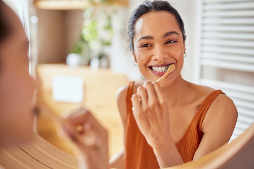 Woman showing how to treat periodontitis by brushing teeth