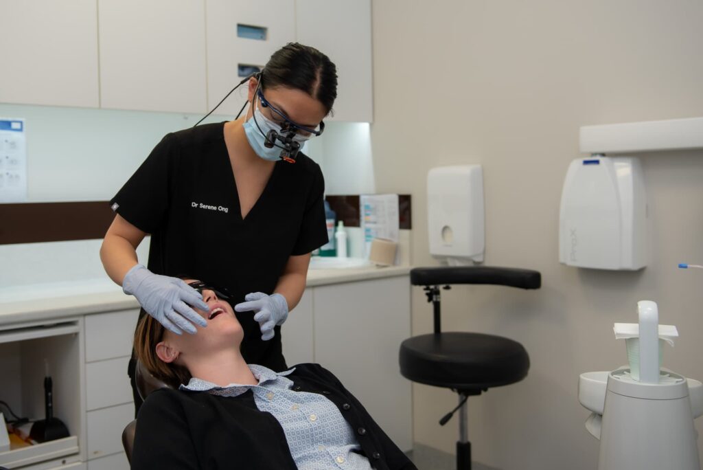 Dentist inspecting patients mouth for periodontitis